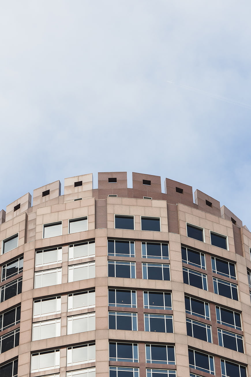 Low angle view of modern curved office building facade