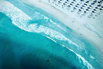 Aerial View of Turquoise Ocean Waves and White Sandy Beach