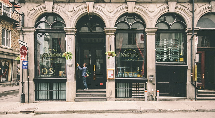 Man entering Santos restaurant on historic Montreal street