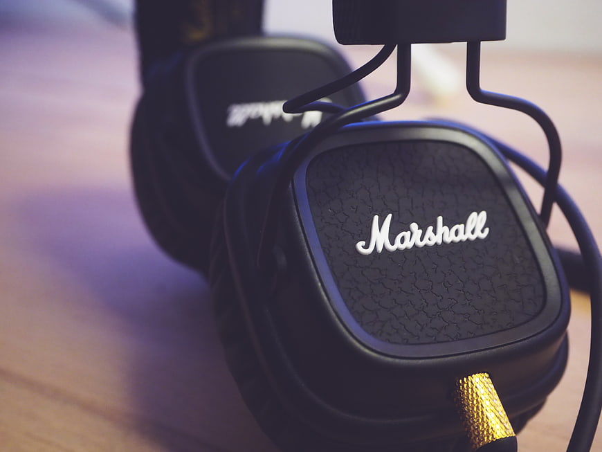 Close-up of black Marshall headphones on wooden surface