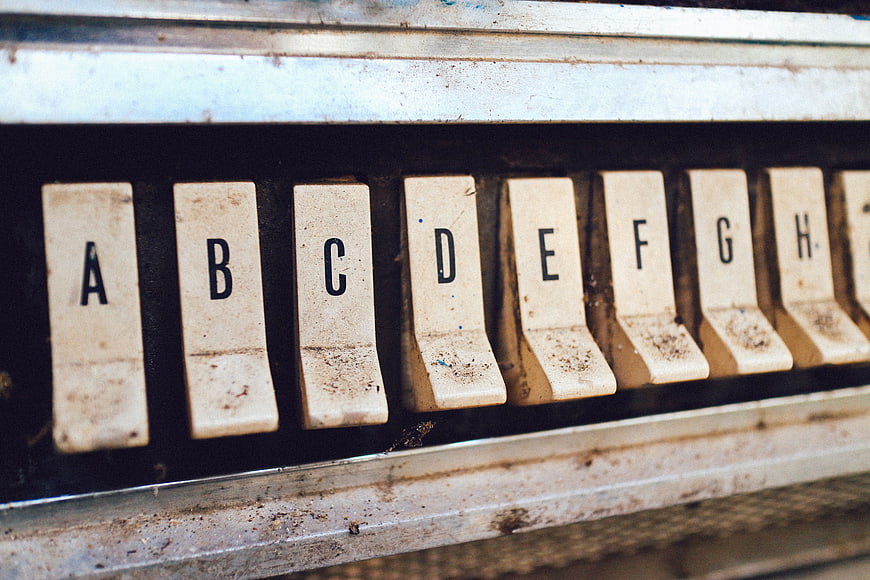 Close-up of vintage dirty typewriter keys with letters
