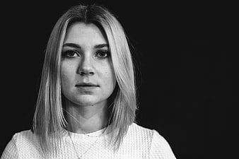 Black and white portrait of a young woman looking at camera