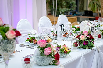 Elegant Wedding Table Setting with Pink and Red Floral Centerpieces