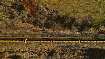 Aerial View of Yellow Freight Train on Rural Tracks