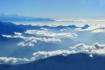 Majestic Mountain Range with Sea of Clouds and Blue Sky