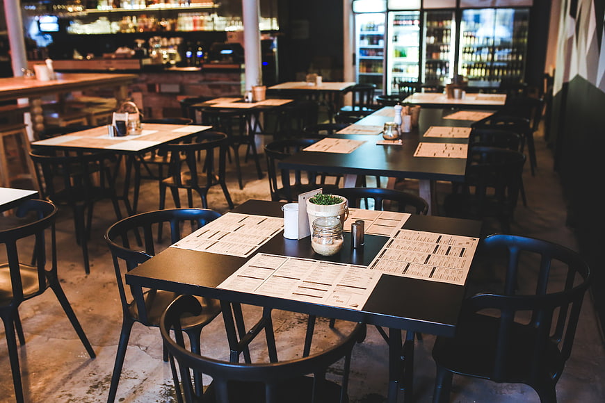 Empty tables and chairs in a modern vintage restaurant interior