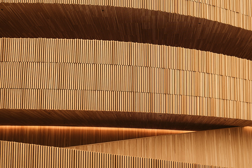 Modern wooden slat architecture with warm lighting
