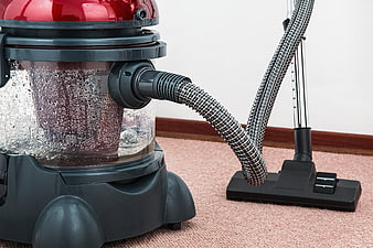 Red Canister Vacuum Cleaner Cleaning Pink Carpet