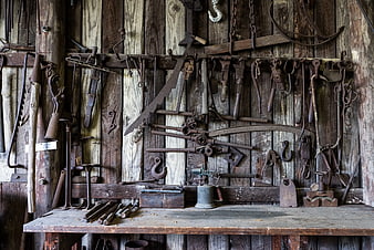 Vintage Rusty Farm Tools on Wooden Barn Wall