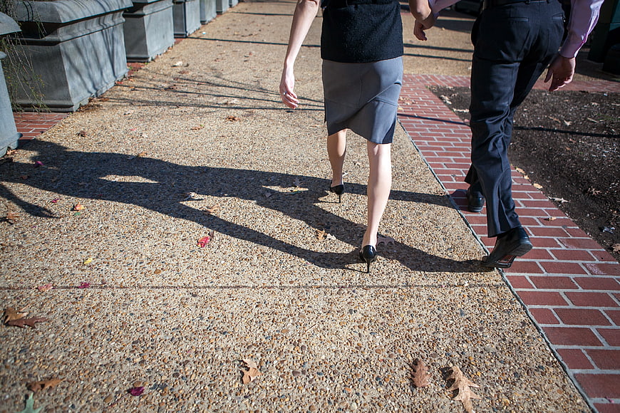 Business Couple Walking Away on Sidewalk