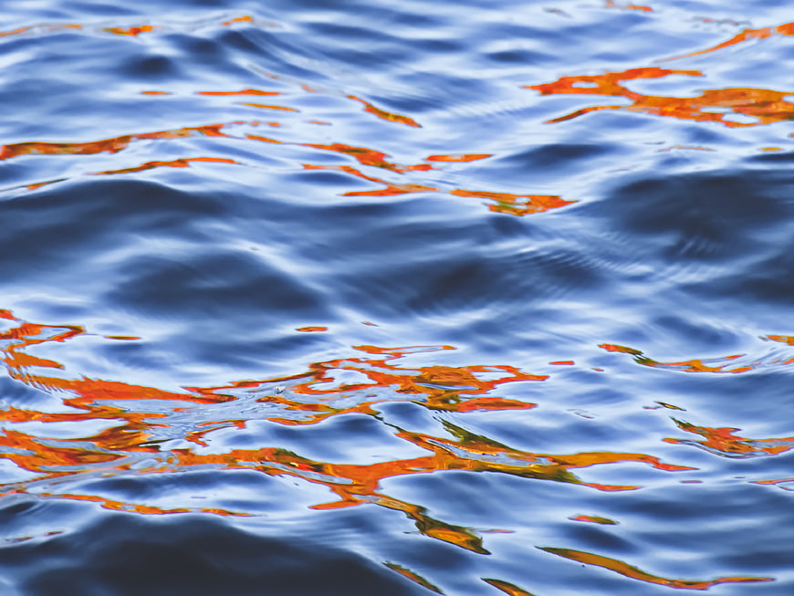 Abstract Blue Water Ripples with Orange Autumn Reflections