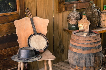 Vintage Wild West Scene with Banjo, Hat, and Barrel
