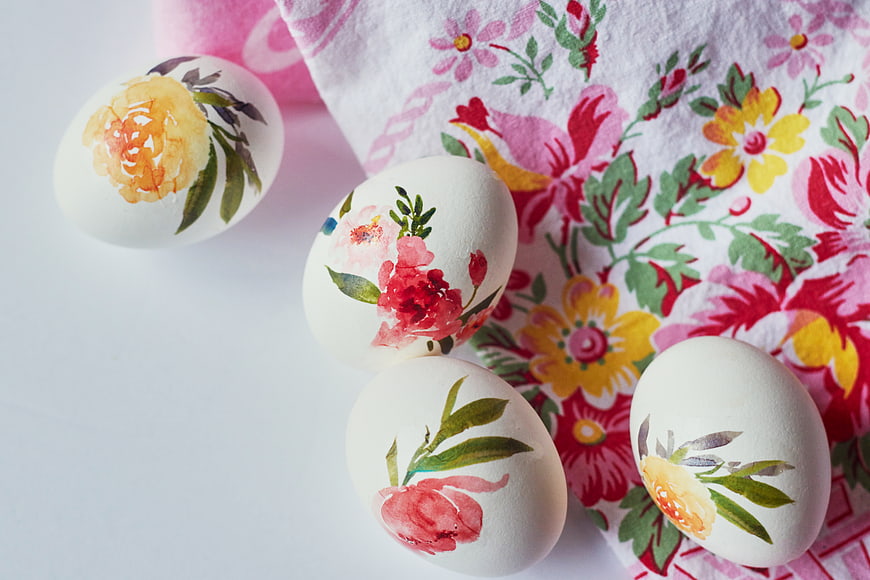 Hand-painted floral Easter eggs on floral cloth