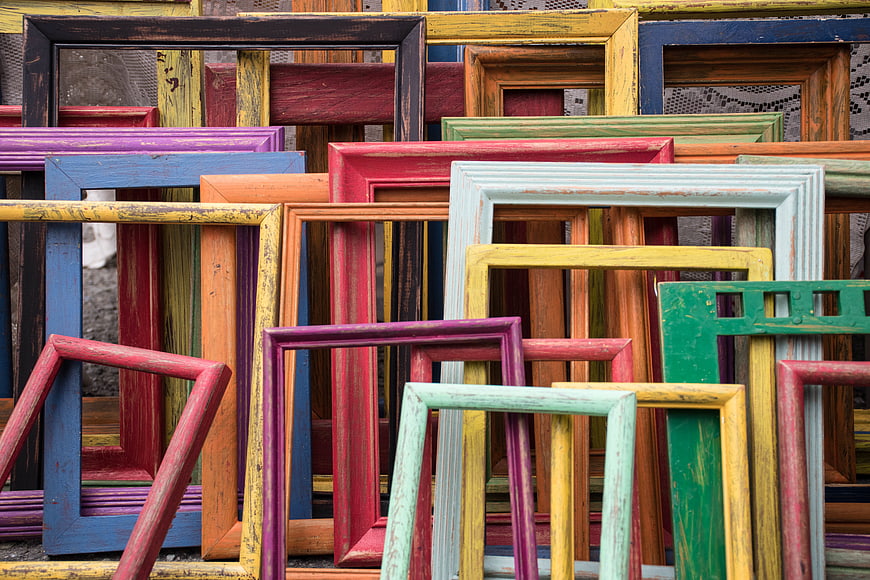 Stack of colorful vintage wooden picture frames