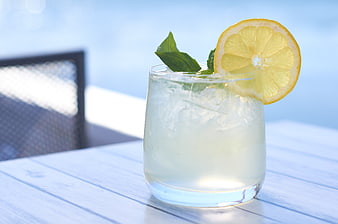 Refreshing Lemon Cocktail with Mint on White Table
