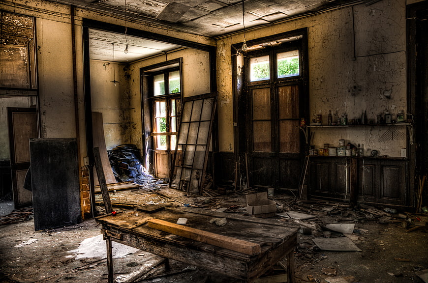 Abandoned Dilapidated Interior Room with Debris and Peeling Walls