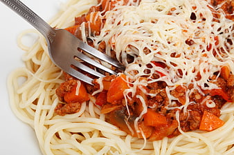 Close-up of spaghetti with meat sauce and melted cheese
