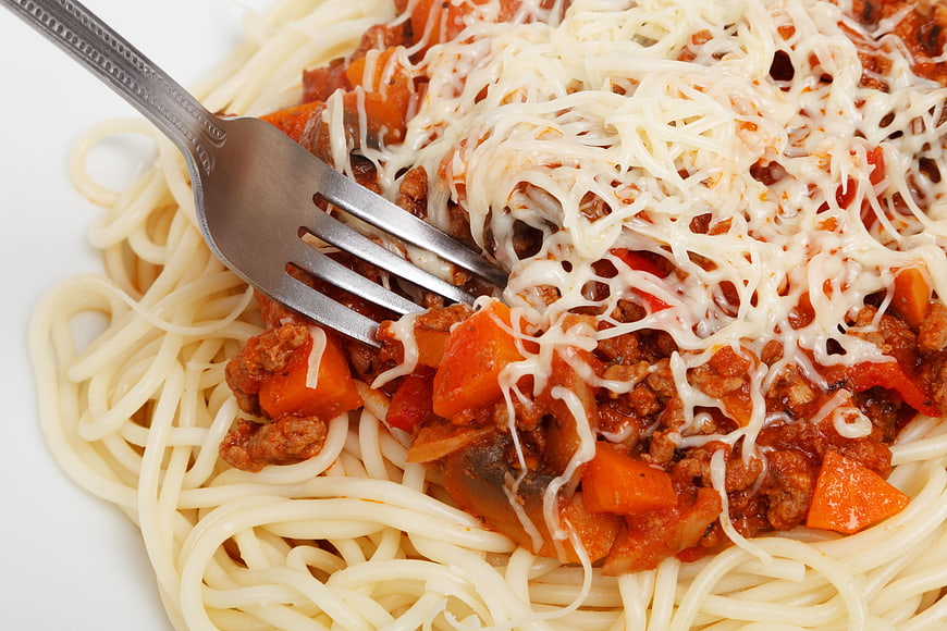 Close-up of spaghetti with meat sauce and melted cheese
