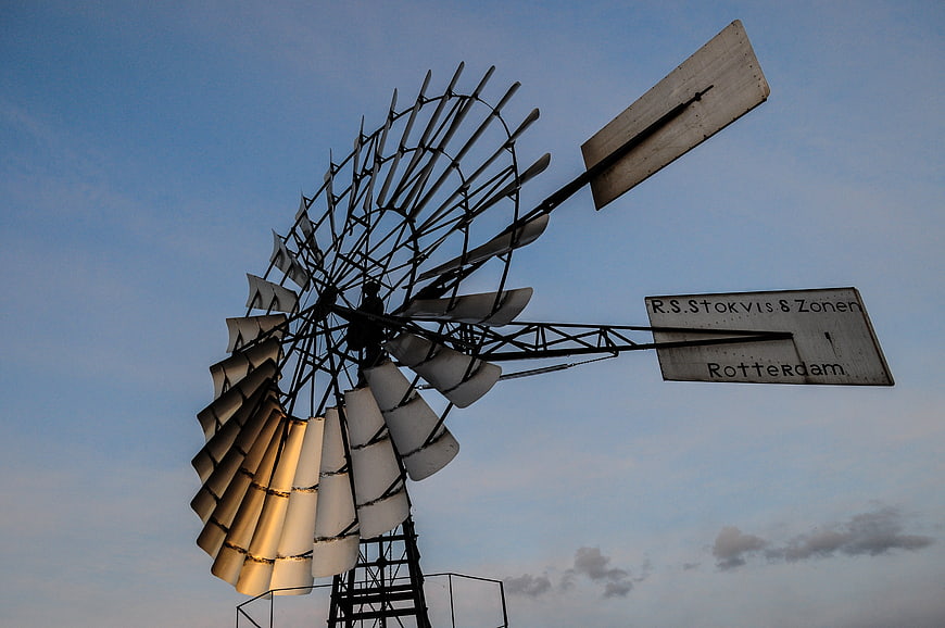 Vintage Stokvis Windmill Silhouette Against Blue Sky