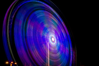 Abstract Light Trails of Spinning Amusement Park Ride at Night