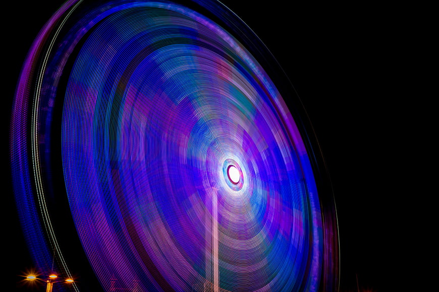 Abstract Light Trails of Spinning Amusement Park Ride at Night