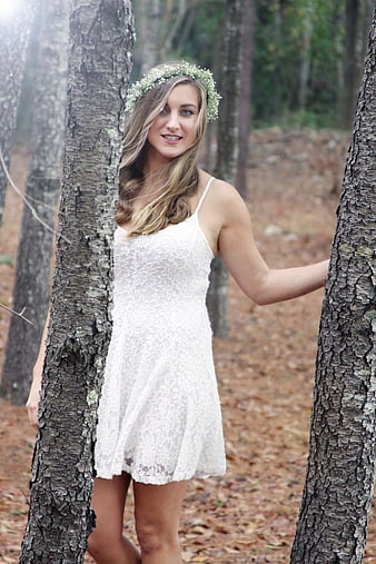 Woman in White Lace Dress with Flower Crown in Forest