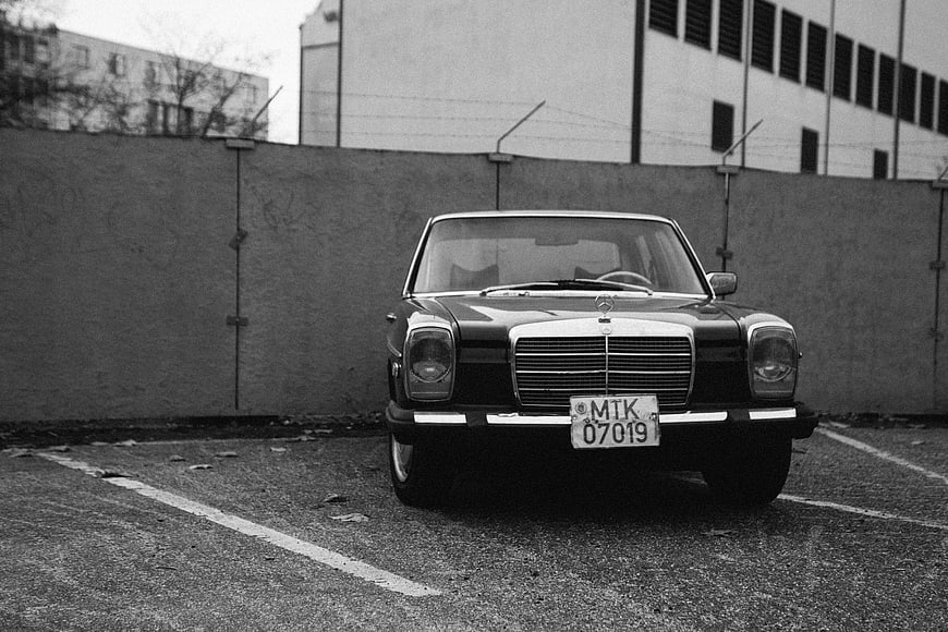 Vintage Mercedes-Benz W123 in Black and White Parking Lot