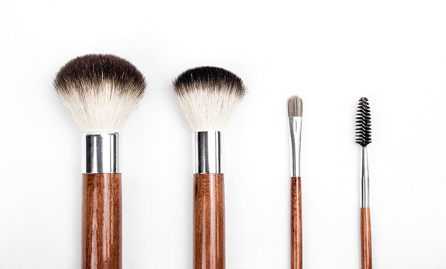 Set of wooden makeup brushes on white background