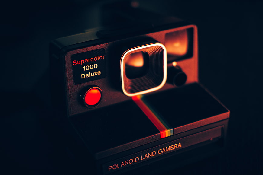 Vintage Polaroid Supercolor 1000 Deluxe Camera in Dark Moody Lighting