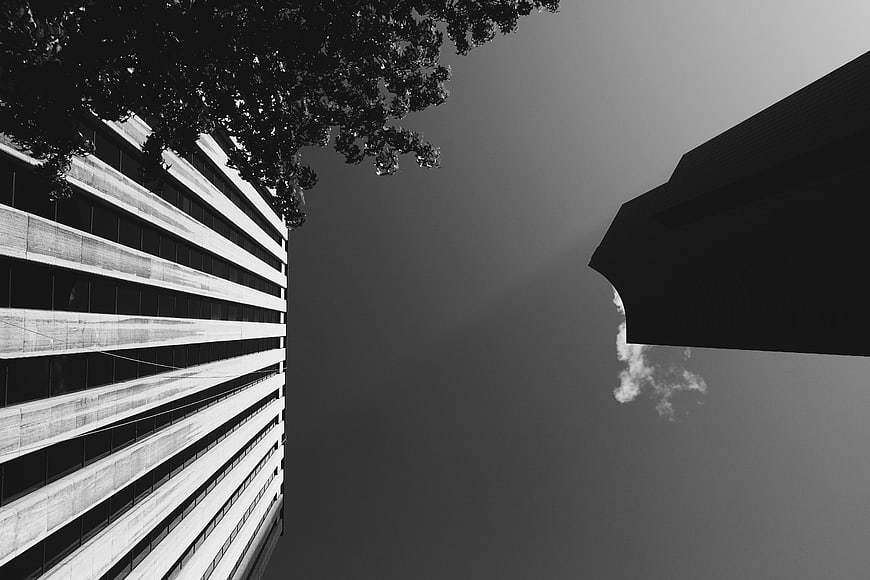 Black and white low angle view of modern architecture and sky