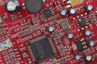 Close-up of red electronic circuit board with microchip