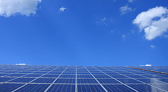 Solar Panels Array Under Blue Sky with Clouds