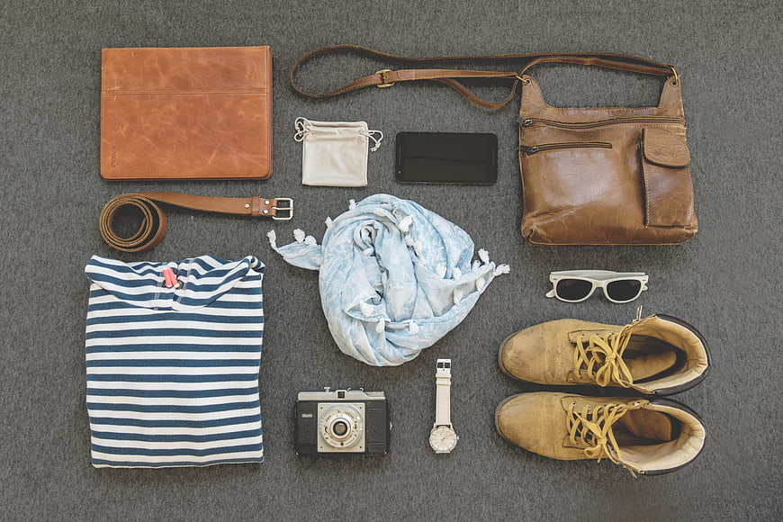 Flat lay of travel accessories and men's fashion items