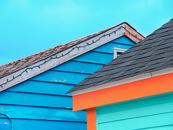 Colorful House Roof Detail Against Blue Sky