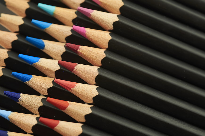 Close-up of black colored pencils with vibrant tips