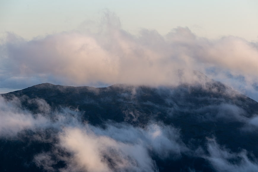 Misty Mountain Peak Shrouded in Clouds at Dusk
