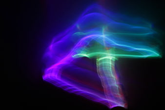 Abstract neon light painting mushroom shape on black background