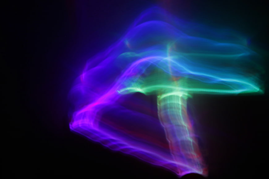 Abstract neon light painting mushroom shape on black background