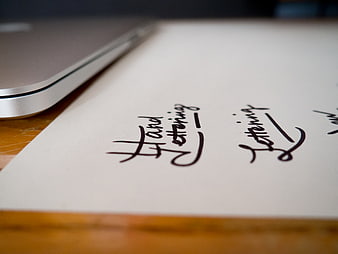 Hand Lettering Practice on Paper with Laptop