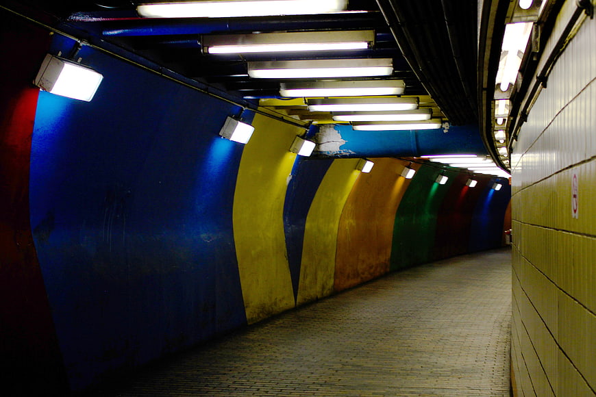 Colorful curved subway tunnel with vibrant blue and yellow walls