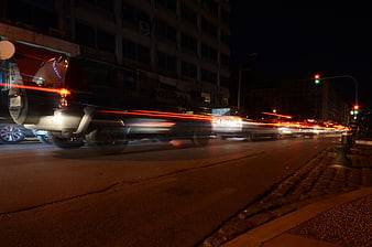 Night traffic with red light trails on city street