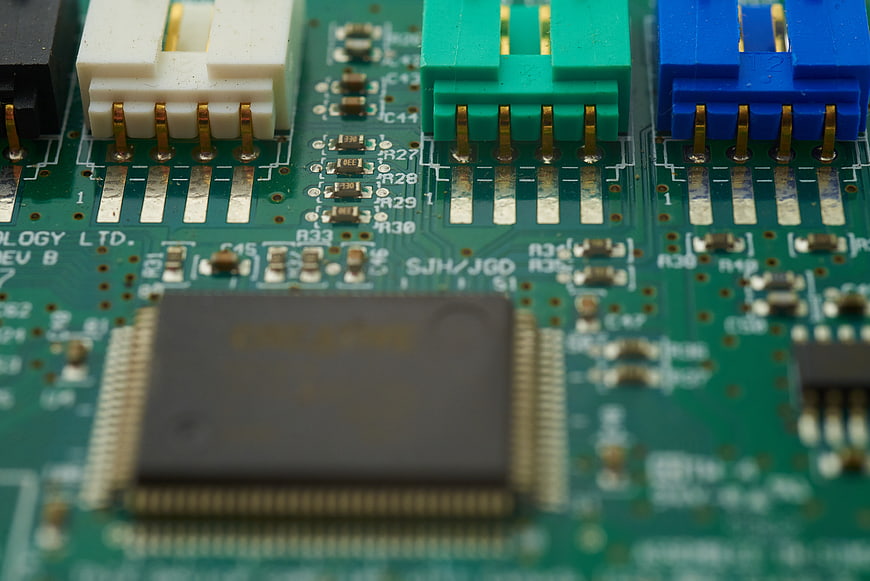 Macro shot of green circuit board with electronic components