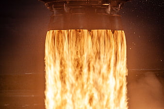 Close-up of rocket engine nozzle with intense flames