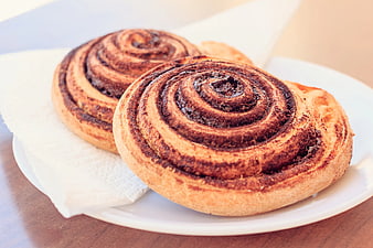 Two Fresh Cinnamon Rolls on White Plate