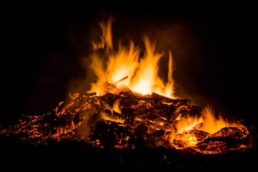 Bonfire burning at night with bright orange flames