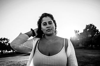 Black and white portrait of confident woman in park