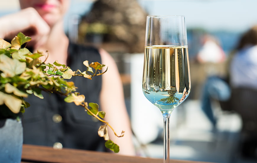 Glass of champagne on outdoor table with blurred background