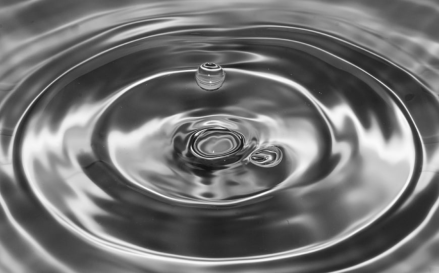 Black and white water drop splash with ripples