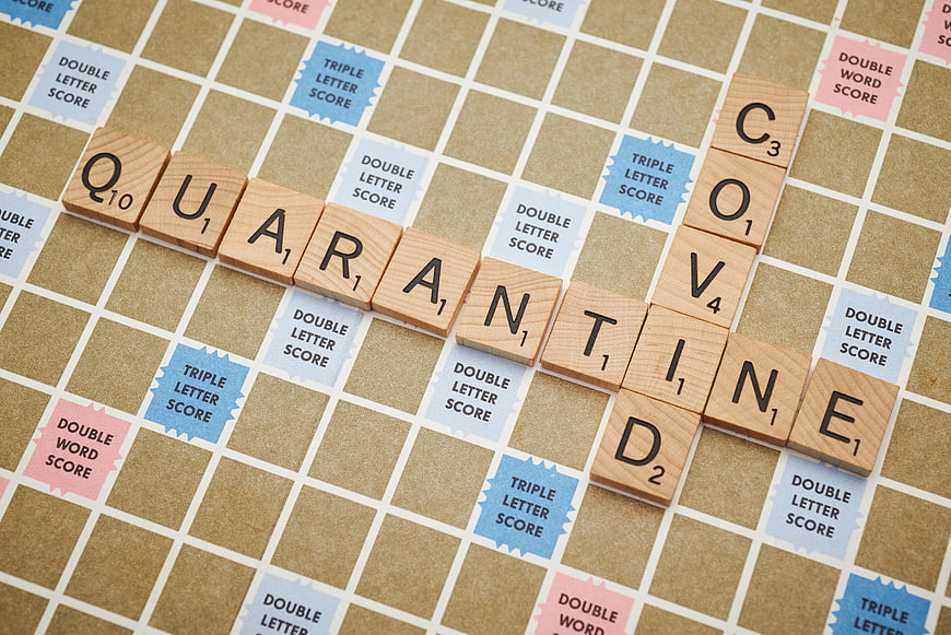 Quarantine spelled with Scrabble tiles on game board