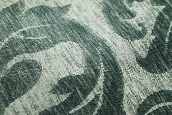 Close-up of green floral woven fabric texture